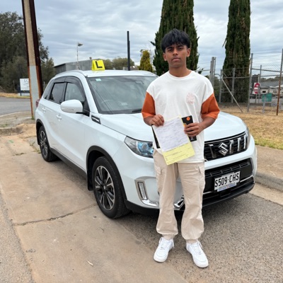 A student with the Adelaide Confident Driving Academy training vehicle after passing his CBT&A assessment